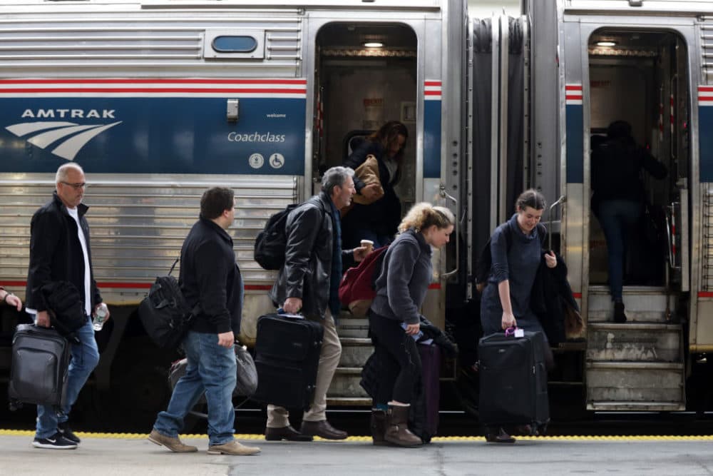 Passengers wait to board an Amtrak train. (Alex Wong/Getty Images)