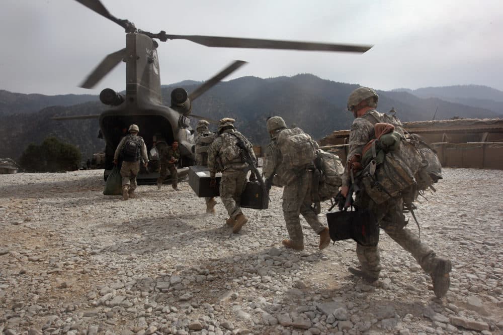 U.S. soldiers board an Army Chinook transport helicopter after it brought fresh soldiers and supplies to the Korengal Outpost on October 27, 2008 in the Korengal Valley, Afghanistan. (John Moore/Getty Images)
