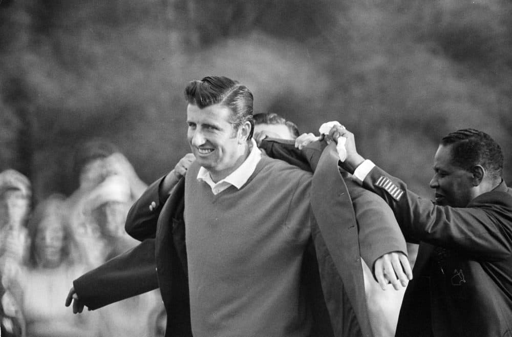 George Archer, winner of the 1969 Masters Tournament, is helped into his green jacket. (AP)