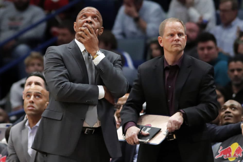 New Orleans Pelicans head coach Alvin Gentry, left, looks on in despair during Tuesday's game against the Brooklyn Nets. The game was the Pelicans' 13th consecutive loss, a franchise record. (Gerald Herbert/AP)