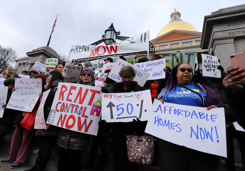 Housing activists swarmed the front steps of the State House on Tuesday before heading back inside to a legislative hearing on rent control. (Sam Doran/SHNS)
