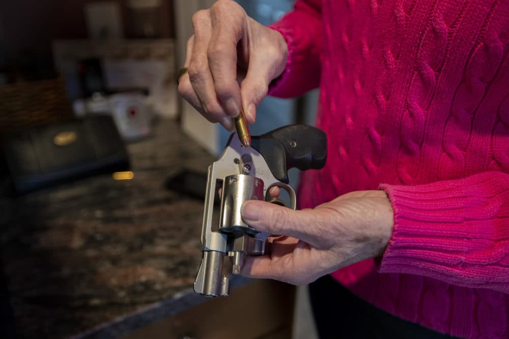 Cynthia English loads her Smith and Wesson revolver. (Jesse Costa/WBUR)