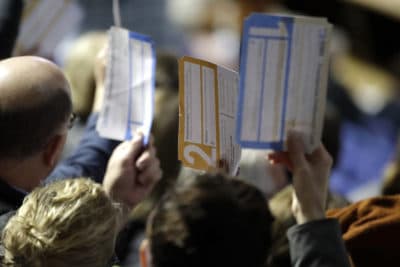 Caucus goers seated in the section for Democratic presidential candidate former Vice President Joe Biden hold up their first votes as they are counted at the Knapp Center on the Drake University campus in Des Moines, Iowa on Monday. (Gene J. Puskar/AP)