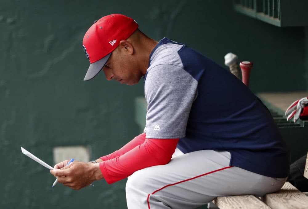 Boston Red Sox manager Alex Cora looks over the lineup before the team's spring training baseball game against the Baltimore Orioles on Wednesday, March 20, 2019, in Sarasota, Fla. (AP Photo/John Bazemore)