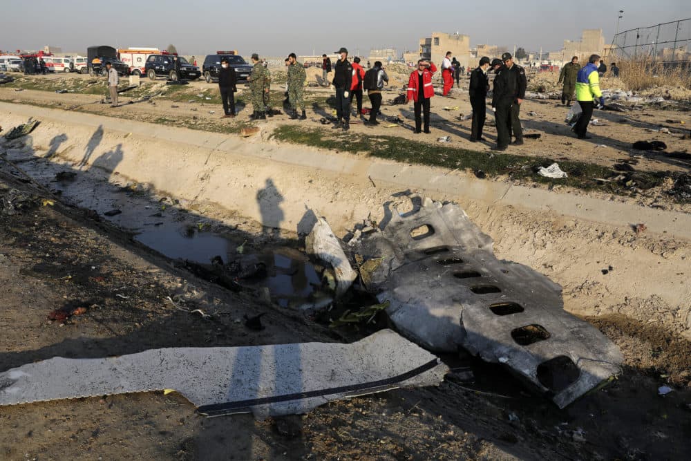 Debris is seen from an Ukrainian plane which crashed as authorities work at the scene in Shahedshahr, southwest of the capital Tehran, Iran, Wednesday, Jan. 8, 2020. (Ebrahim Noroozi/AP)