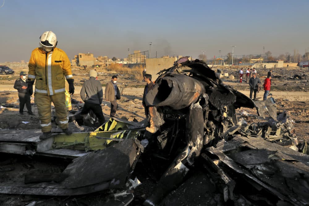 Rescue workers search the scene where a Ukrainian plane crashed in Shahedshahr, southwest of the Iranian capital, Wednesday. (Ebrahim Noroozi/AP)