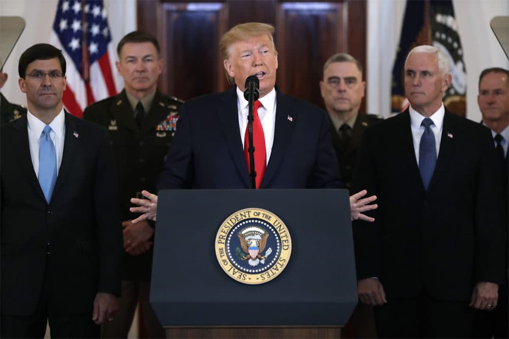 President Donald Trump addresses the nation from the White House on the ballistic missile strike that Iran launched against Iraqi air bases housing U.S. troops, Wednesday, in Washington, as Vice President Mike Pence and others looks on. (Evan Vucci/AP)