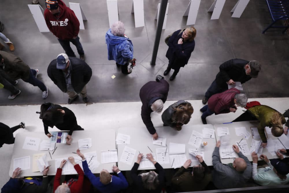 Caucus goers check in before Democratic presidential candidate Sen. Elizabeth Warren, D-Mass., speaks at a caucus at Roosevelt Hight School, Monday, Feb. 3, 2020, in Des Moines, Iowa. (Andrew Harnik/AP)