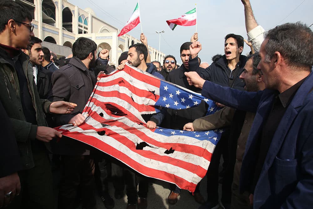 Iranians tear up a U.S. flag during a demonstration in Tehran on January 3, 2020 following the killing of Iranian Revolutionary Guards Major General Qasem Soleimani in a US strike on his convoy at Baghdad international airport. (ATTA KENARE/AFP via Getty Images)