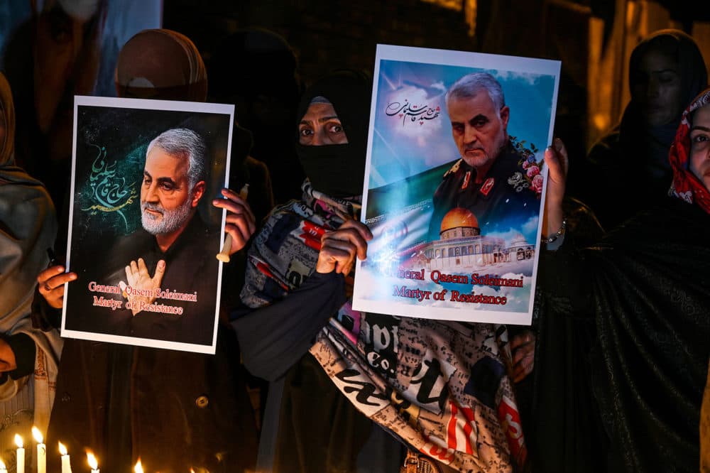 Shiite Muslims hold pictures of slain top Iranian general Qasem Soleimani to pay him tribute during a candle light vigil in Islamabad January 8, 2020. (Aamir Qureshi/AFP via Getty Images)