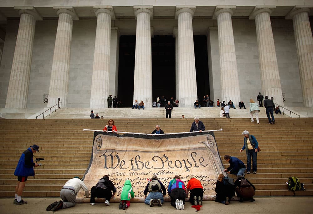 Volunteers help roll up a giant banner printed with the Preamble to the United States Constitution during a demonstration against the Supreme Court's Citizens United ruling at the Lincoln Memorial on the National Mall October 20, 2010 in Washington, DC. The rally at the memorial was organized by brothers Laird and Robin Monahan who spent the last five months walking from San Francisco, California, to Washington to protest the court decision, which overturned the provision of the McCain-Feingold law barring corporations and unions from paying for political ads made independently of candidate campaigns. (Chip Somodevilla/Getty Images)