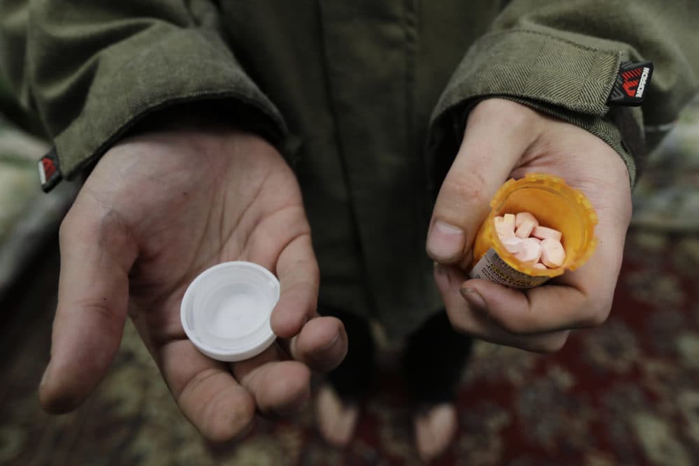 In this 2019 file photo, a man in Olympia, Wash., holds his bottle of buprenorphine, a medicine that prevents withdrawal sickness in people trying to stop using opiates. (Ted S. Warren/AP)