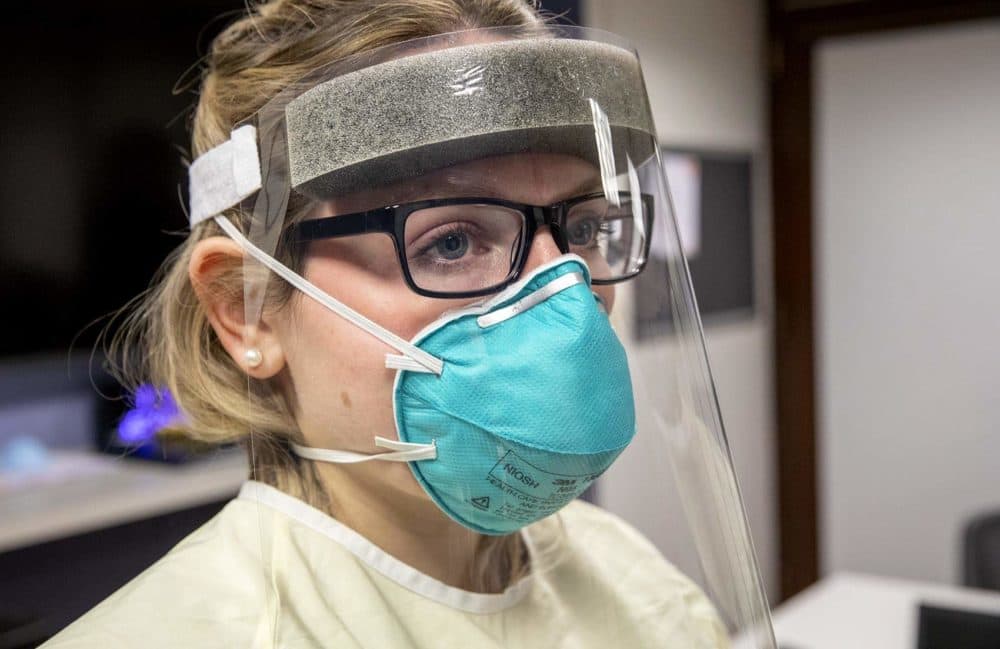 Erica Parziale, an emergency management intern at Tufts Medical Center, wears an N95 mask under a face shield. (Robin Lubbock/WBUR)