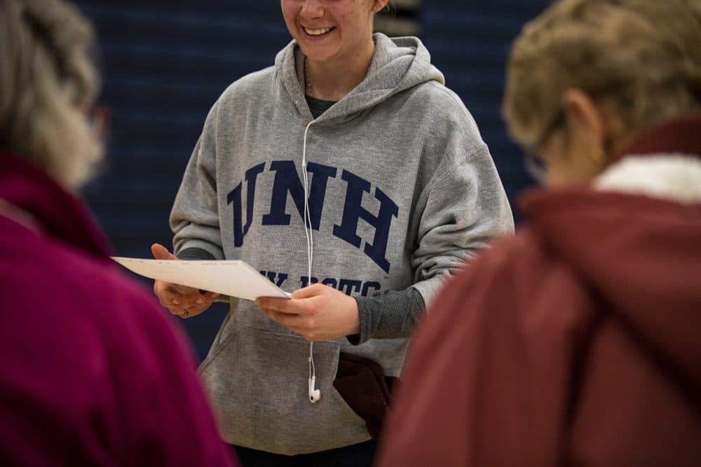 A UNH student recieves her ballot at the polls at Oyster River High School in Durham, N.H. (Jesse Costa/WBUR)