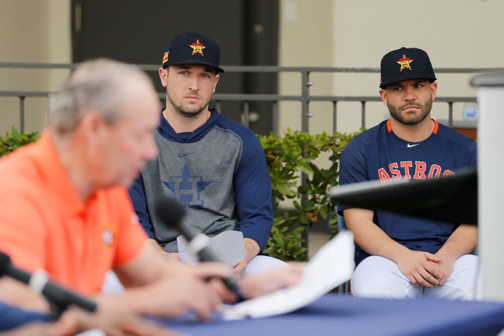 Alex Bregman and Jose Altuve of the Houston Astros look on as owner Jim Crane reads a prepared statement during a press conference on Thursday. (Michael Reaves/Getty Images)