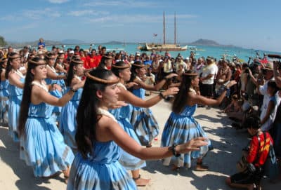 Hula dancers welcome the sailing crew into Kailua Bay in Kailua, Hawaii. (Ronen Zilberman/AP)