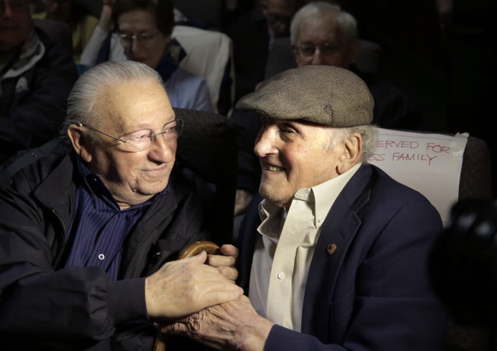 Holocaust survivors Israel Arbeiter, left, and Steve Ross greet one another at a theater before the 2017 premier of the film &quot;Etched in Glass: The Legacy of Steve Ross,&quot; in West Newton, Mass. Ross, a Holocaust survivor who spent decades searching for the soldier who helped him at a concentration camp in 1945, died Monday. (Steven Senne/AP File Photo)