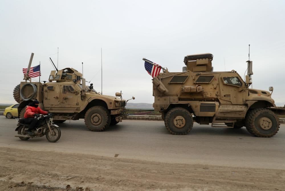 A US military convoy drives on the outskirts of the Kurdish-controlled northern Syrian city of Qamishli on February 12, 2020. (Delil Souleiman/AFP)
