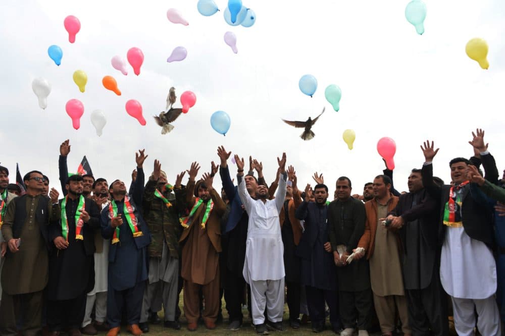 Youth release balloons and pigeons as they celebrate the reduction in violence, in Jalalabad on February 28, 2020. (NOORULLAH SHIRZADA/AFP via Getty Images)