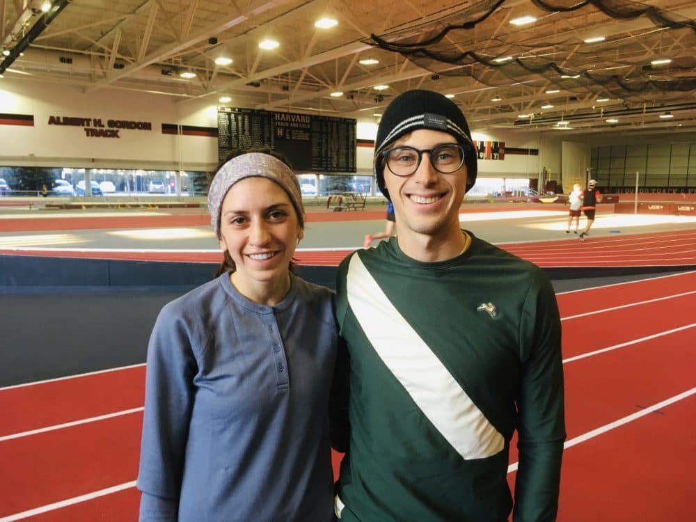 Lou Serafini poses with Gabi Drummond at Harvard's Gordon Indoor Track. Both will be running in the Olympic Marathon Trials in Atlanta. (Alex Ashlock/WBUR)