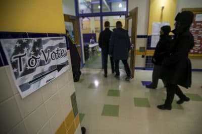 Voters file into the gymnasium of the Michael E. Capuano School in Somerville as the polls open early this morning. (Jesse Costa/WBUR)