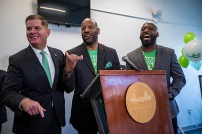 Boston Mayor Marty Walsh, and Pure Oasis co-owners Kobie Evans and Kevin Hart celebrate and announce the opening of the first marijuana dispensary located in Boston. (Jesse Costa/WBUR)