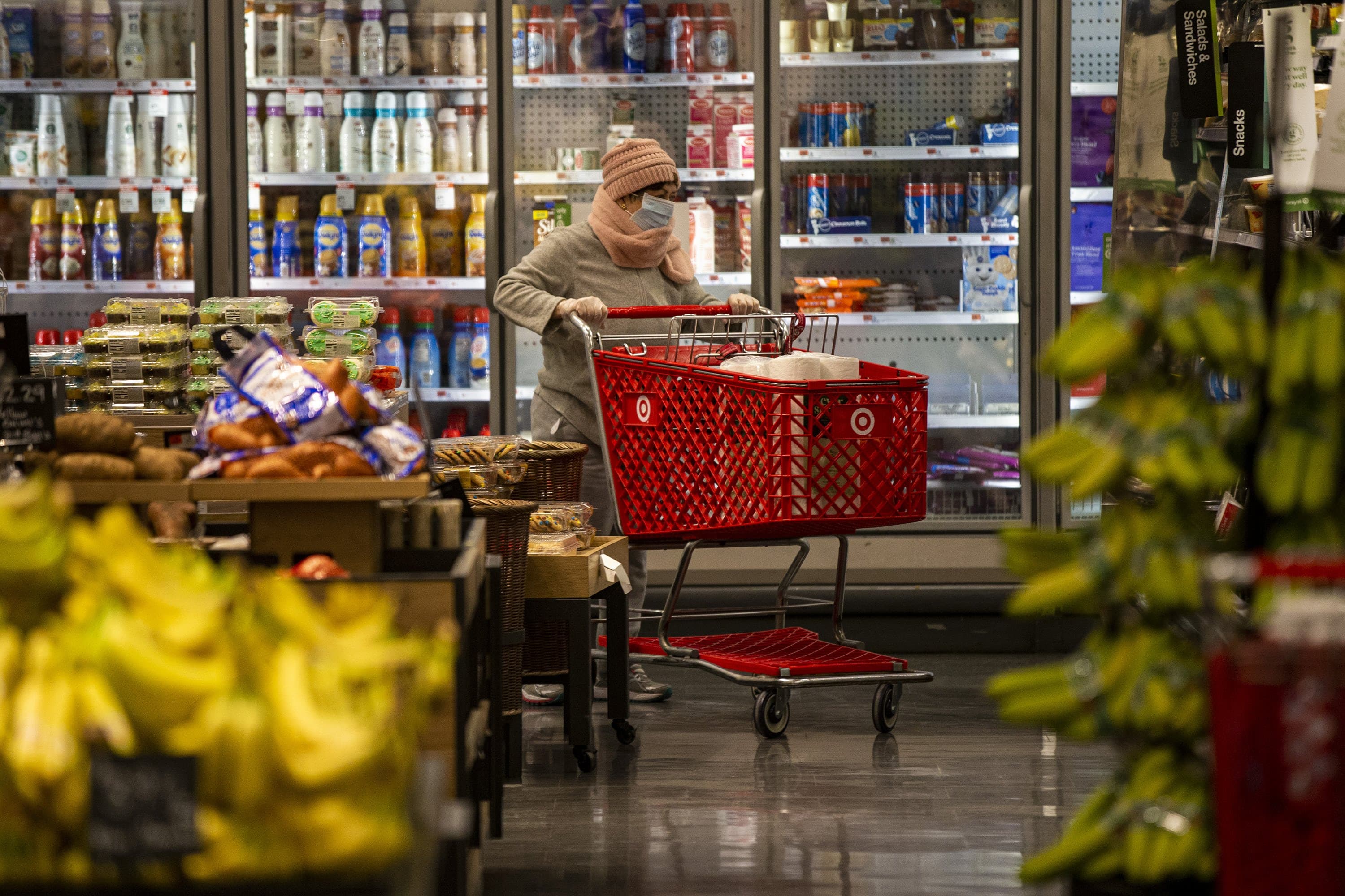 A woman wears a face mask shopping at Target in Watertown. (Jesse Costa/WBUR)