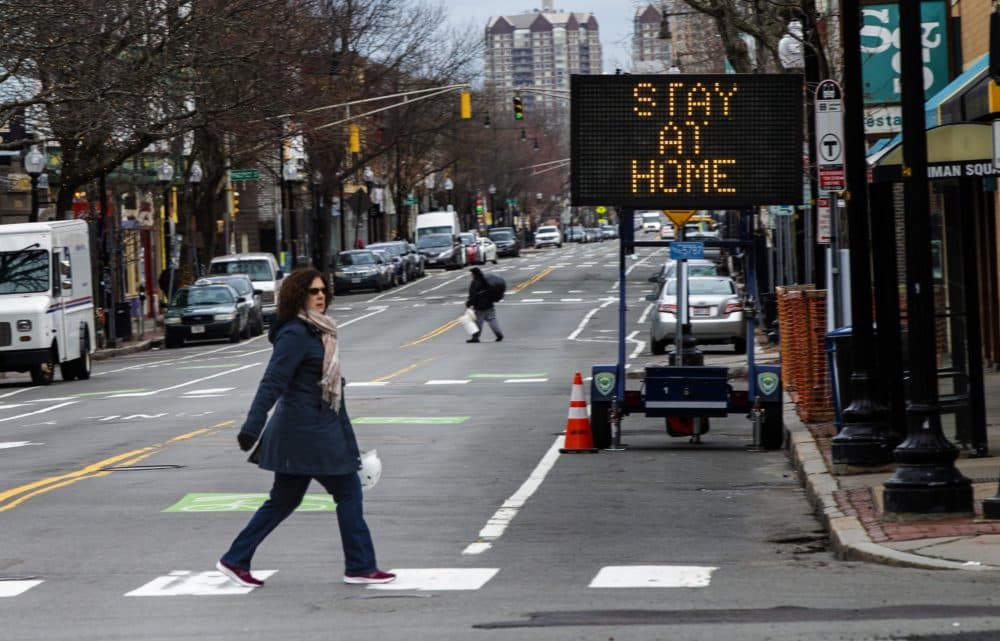 A sign in Inman Square in Cambridge urging residents to stay home during the Coronavirus epidemic, March 25, 2020. (Jesse Costa/WBUR)