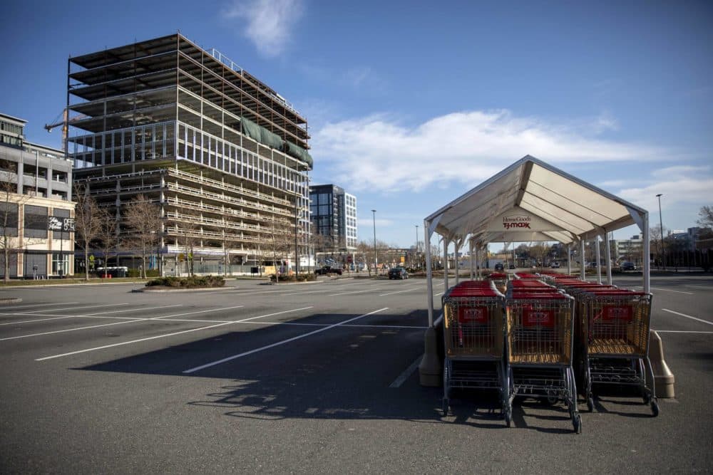 With stores closed and people staying home to slow the spread of the coronavirus, TJ Max carts stand idle in the empty car park in front of the store at Assembly Square. (Robin Lubbock/WBUR)