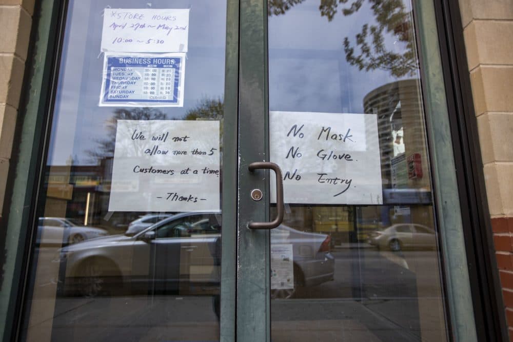 The list of restrictions on the door due to the coronavirus pandemic at Star Fish Market in Egleston Square. (Jesse Costa/WBUR)