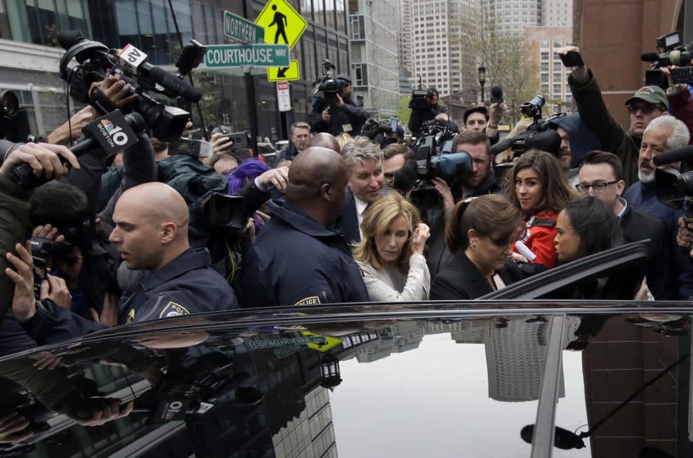 Felicity Huffman, center, gets into a vehicle followed by her brother Moore Huffman Jr., outside federal, Monday, May 13, 2019, in Boston, where she pleaded guilty to charges in a nationwide college admissions bribery scandal. (Steven Senne/AP)