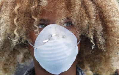 Levi Draheim, 11, wears a dust mask as he participates in a demonstration, Friday, July 12, 2019, in front of the Miami City Hall in Miami. Several youth organizations participated in the demonstration and die-in ahead of the start of Youth Climate Summit in Miami. (Wilfredo Lee/AP)