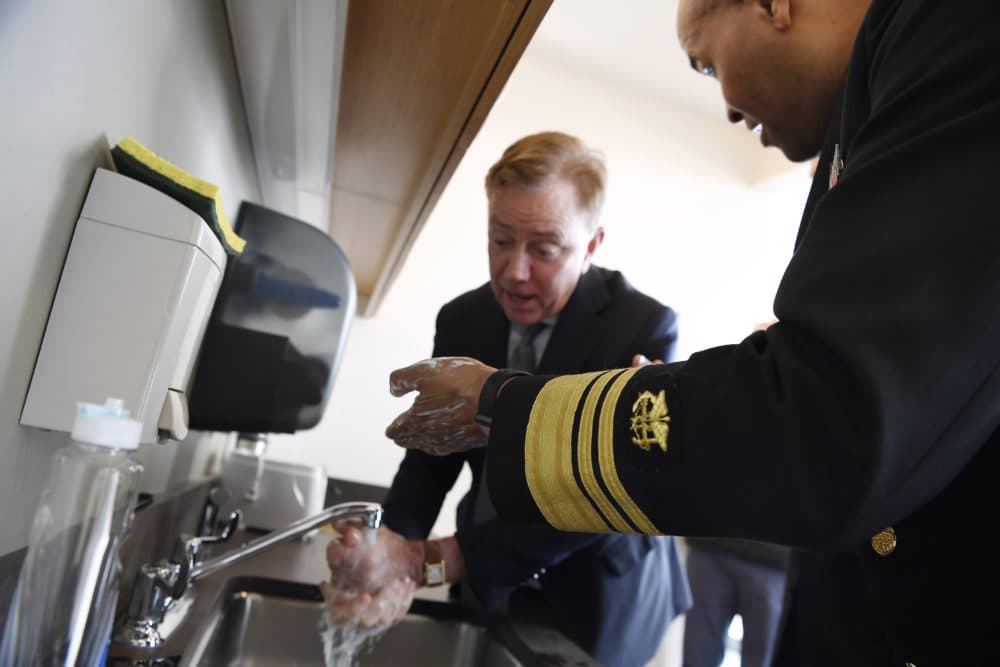 U.S. Surgeon General Vice Admiral Jerome M. Adams demonstrates how long to wash hands with Connecticut Gov. Ned Lamont during a visit the Connecticut State Public Health Laboratory, Monday, March 2, 2020, in Rocky Hill, Conn. (Jessica Hill/AP)
