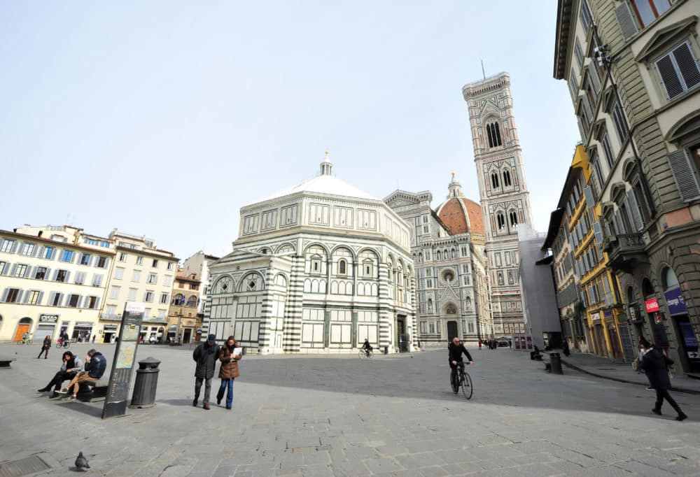 Few people walk in Piazza Duomo square, in Florence, Italy, Tuesday, March 10, 2020. (Jennifer Lorenzini/LaPresse via AP)