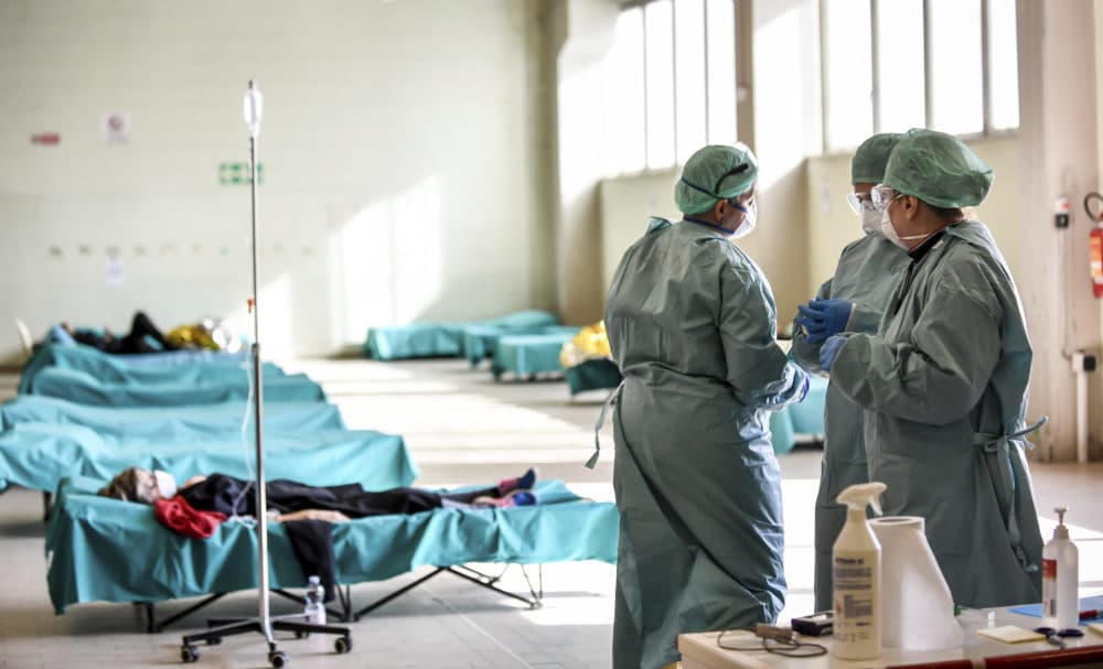 Medical personnel work inside one of the emergency structures that were set up to ease procedures at the hospital of Brescia, Northern Italy, on Tuesday. (Claudio Furlan/LaPresse via AP)