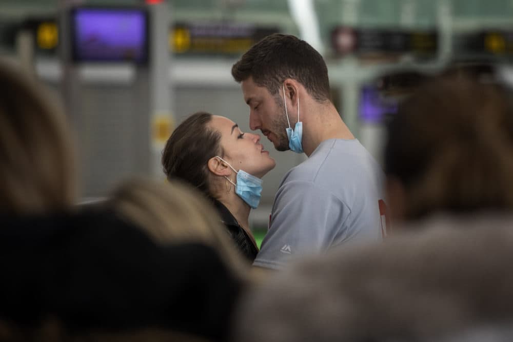 A couple kiss,  at the Barcelona airport, Spain, Thursday, March 12, 2020. (Emilio Morenatti/AP)