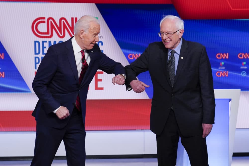 Former Vice President Joe Biden, left, and Sen. Bernie Sanders, I-Vt., right, greet one another before they participate in a Democratic presidential primary debate at CNN Studios in Washington, Sunday, March 15, 2020. (Evan Vucci/AP)