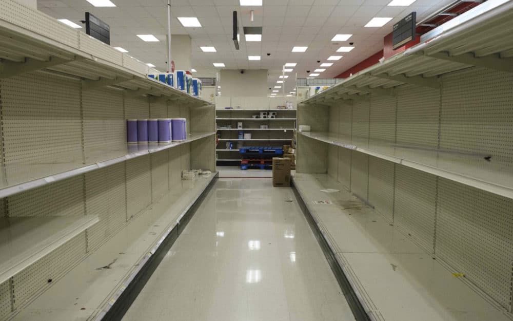 Shelves stand emptied by customers at a local retail store in New York. (Yuki Iwamura/AP)