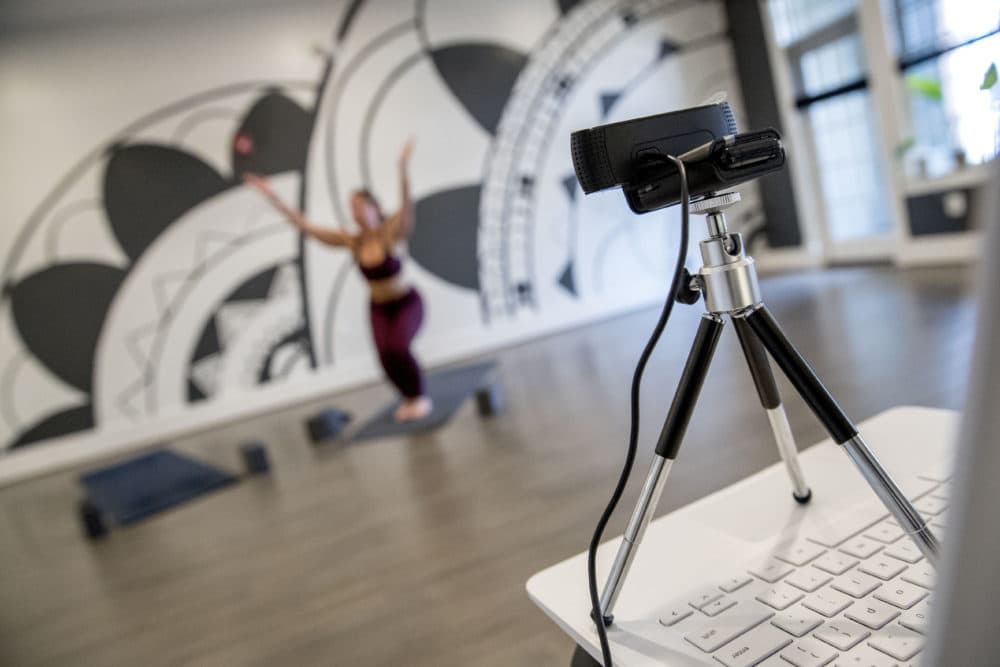 Owner Elyse DiBartolo holds a yoga class via webcam at Haus Yoga on H Street in Northeast Washington, Tuesday, March 17, 2020. DiBartolo is offering two online classes, one free class and one class just for their members, every day during the coronavirus self quarantine. (AP Photo/Andrew Harnik)