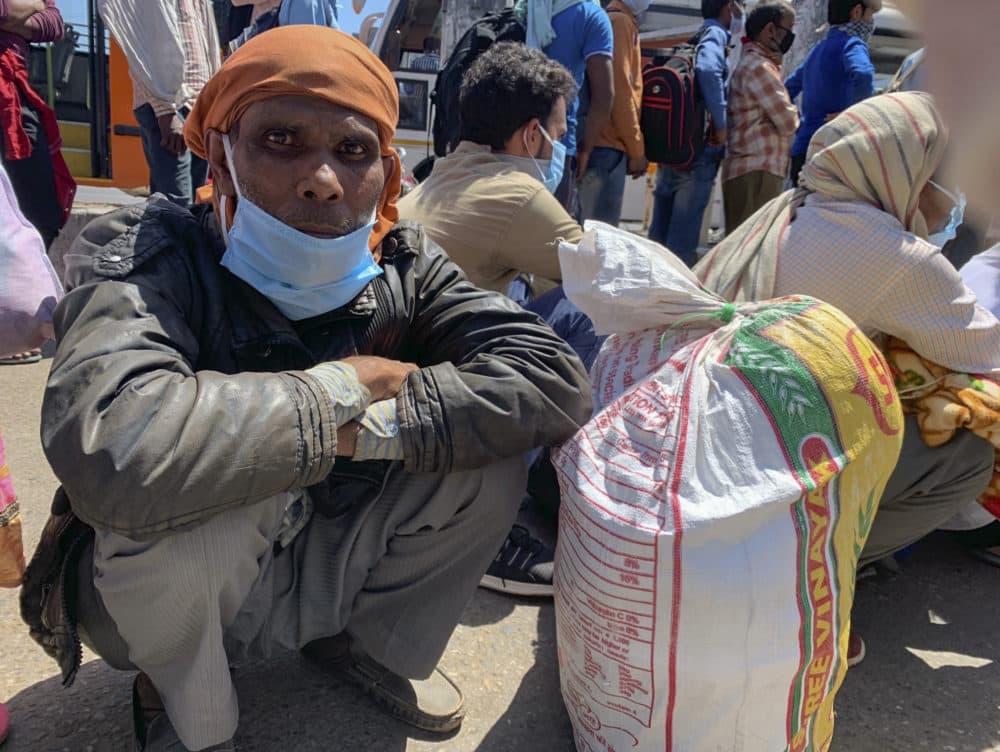 R.K. Sharma, 53, who is among hundreds waiting in line to cross a border to the neighboring state of Uttar Pradesh, in New Delhi, India, Sunday, March 29, 2020. (Emily Schmall/AP Photo)