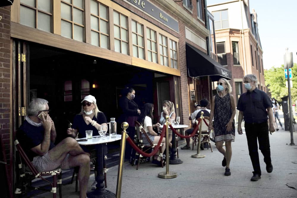 Passers-by, right, walk past diners at a cafe, June 25, 2020, in Boston. (Steven Senne/AP)