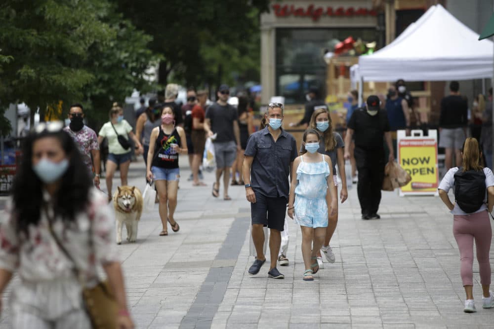 Pedestrians wear masks out of concern for the coronavirus, June 28, 2020, while walking along a sidewalk, in Boston.(Steven Senne/AP)