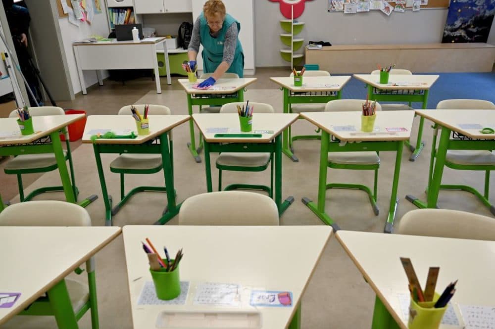 An employee disinfects a classroom of a school. (Sergei Supinsky/AFP/Getty Images)