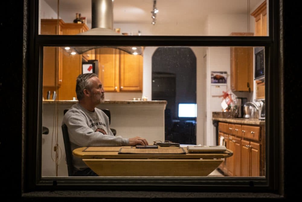 Charlie McDonald, 59, who is suffering from the novel coronavirus (Covid-19) watches CNN in his kitchen in Naples in Naples, Florida. (ZAK BENNETT/AFP via Getty Images)