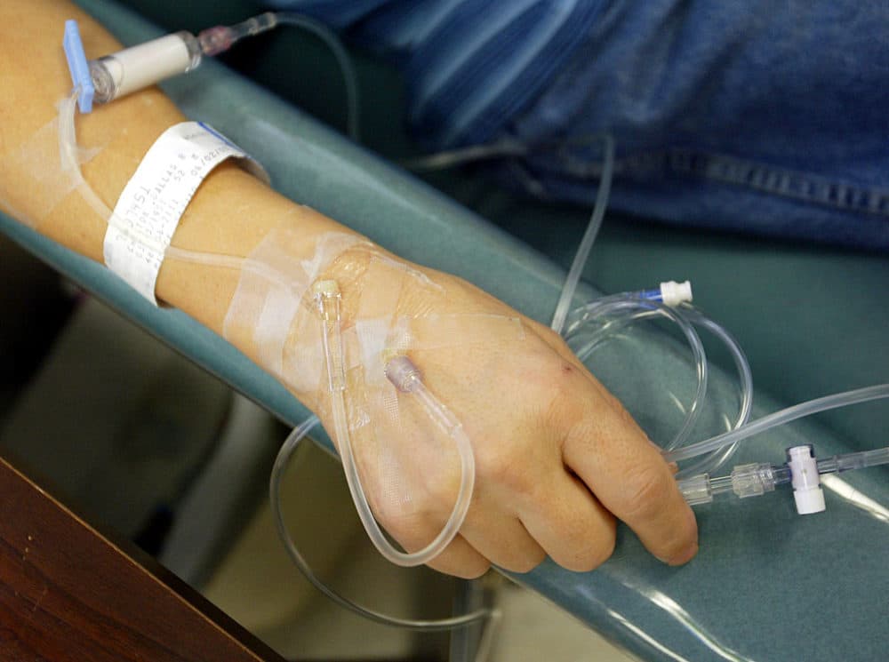 A cancer patient holds the tubes that funnel chemotherapy drugs into his body at Cape Fear Valley Medical Center in Fayetteville, North Carolina. (Chris Hondros/Getty Images)