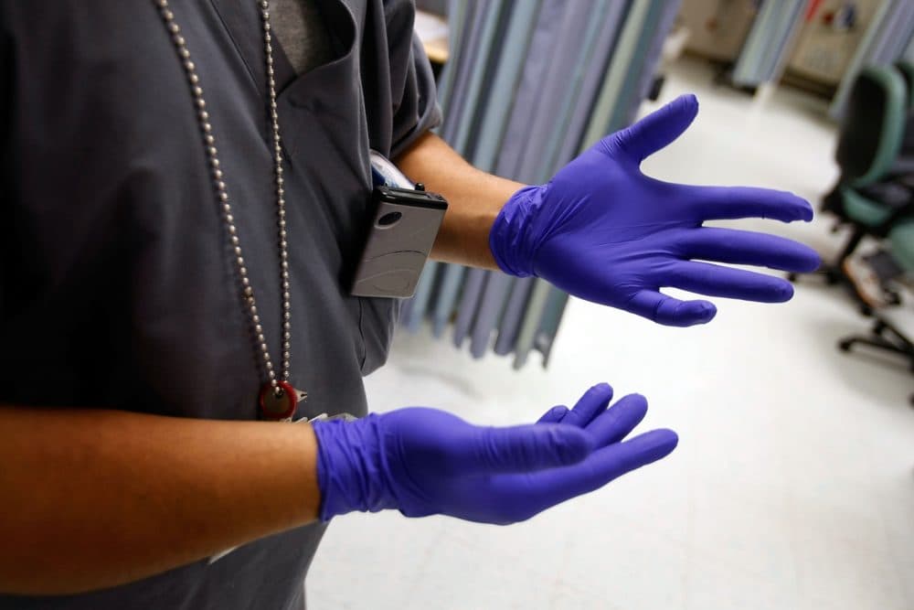 One of the first things health care workers learn is the proper way to put on, wear and dispose of Proper Protective Equipment gloves. (Joe Raedle/Getty Images)