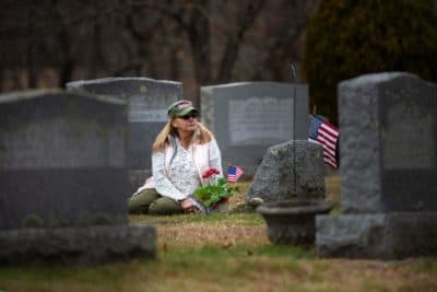 Susan Chamberlain visits the grave of her late husband, Kevin Chamberlain, in Andover. (Jesse Costa/WBUR)