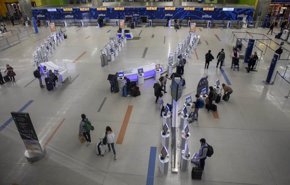 In this file photo, light passenger traffic through the jetBlue check-in area at Logan Airport. (Robin Lubbock/WBUR)