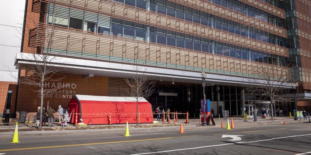 A red tent for testing some patients for coronavirus by appointment near one of the entrances outside the Shapiro Ambulatory Care Center at Boston Medical Center on March 16. (Robin Lubbock/WBUR)