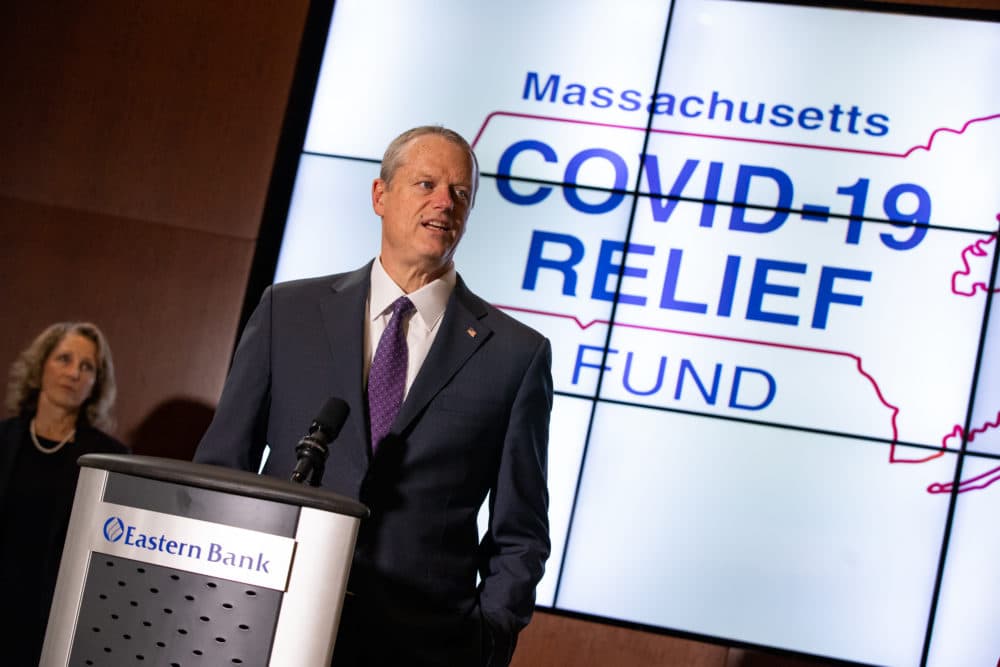 Gov. Charlie Baker, with First Lady Lauren Baker behind him, announces the formation of statewide COVID-19 relief fund.
(Sam Doran/State House News Service)